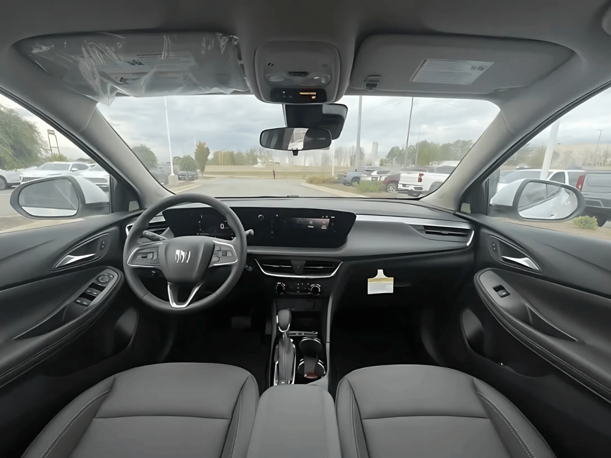 Interior view of the 2025 Buick Encore GX from the front seats showing a modern dashboard and noise-insulated cabin