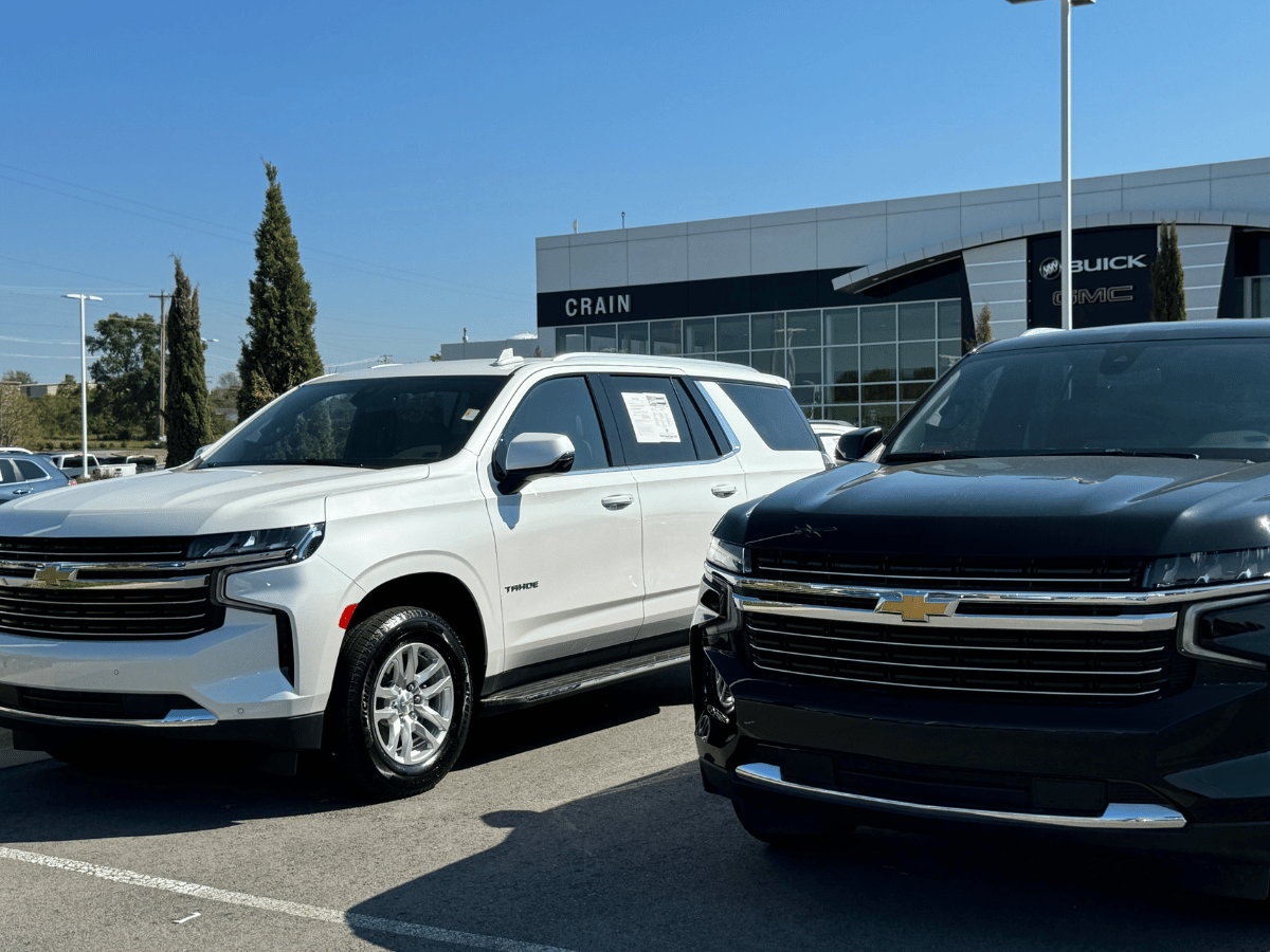 Two Chevrolet SUVs parked in front of Crain Buick GMC dealership on a clear day, showcasing top trade-in value options.
